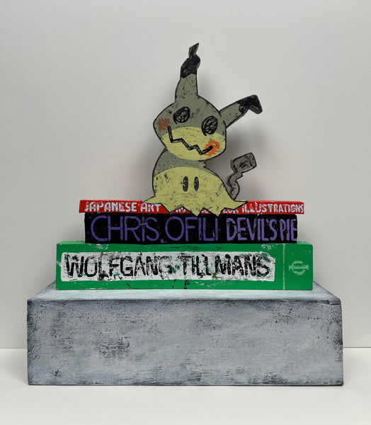 (Jonathan Edelhuber) "Still Life With Pokemon Sculpture on Art Books"